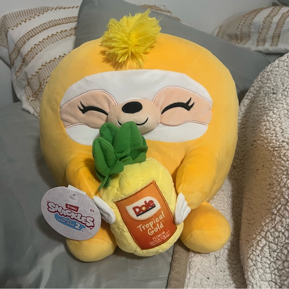 Zuru Snackles Series 2 "Sandy the Sloth" Plush holding a Dole Pineapple